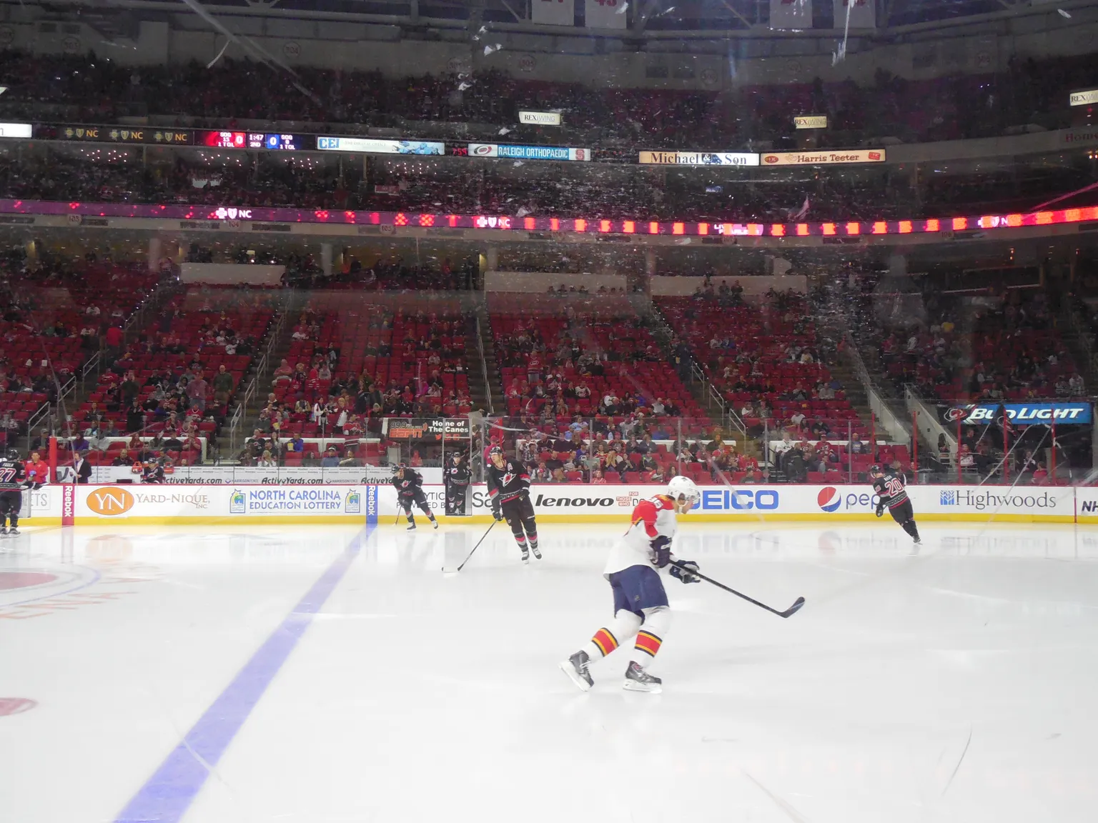 Archival image of Carolina Hurricanes and Florida Panthers players contesting the puck in a 2015 game in Raleigh.