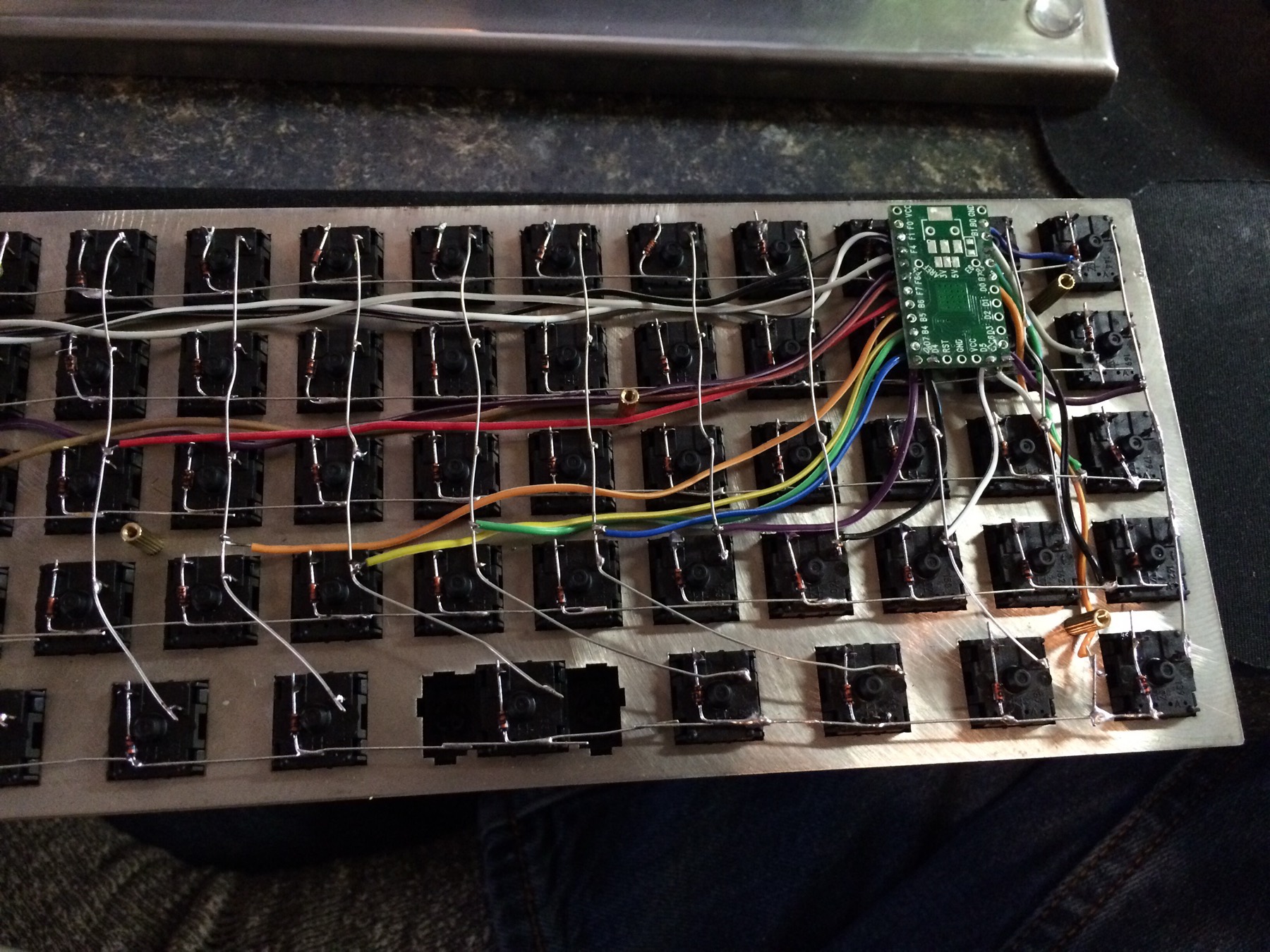 Row buses running the width of the board, column wires bundling toward the controller